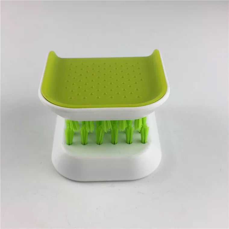 U-shaped cleaning brush held safely around a knife blade