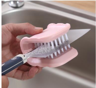 Kitchen knife cleaning brush shown in use