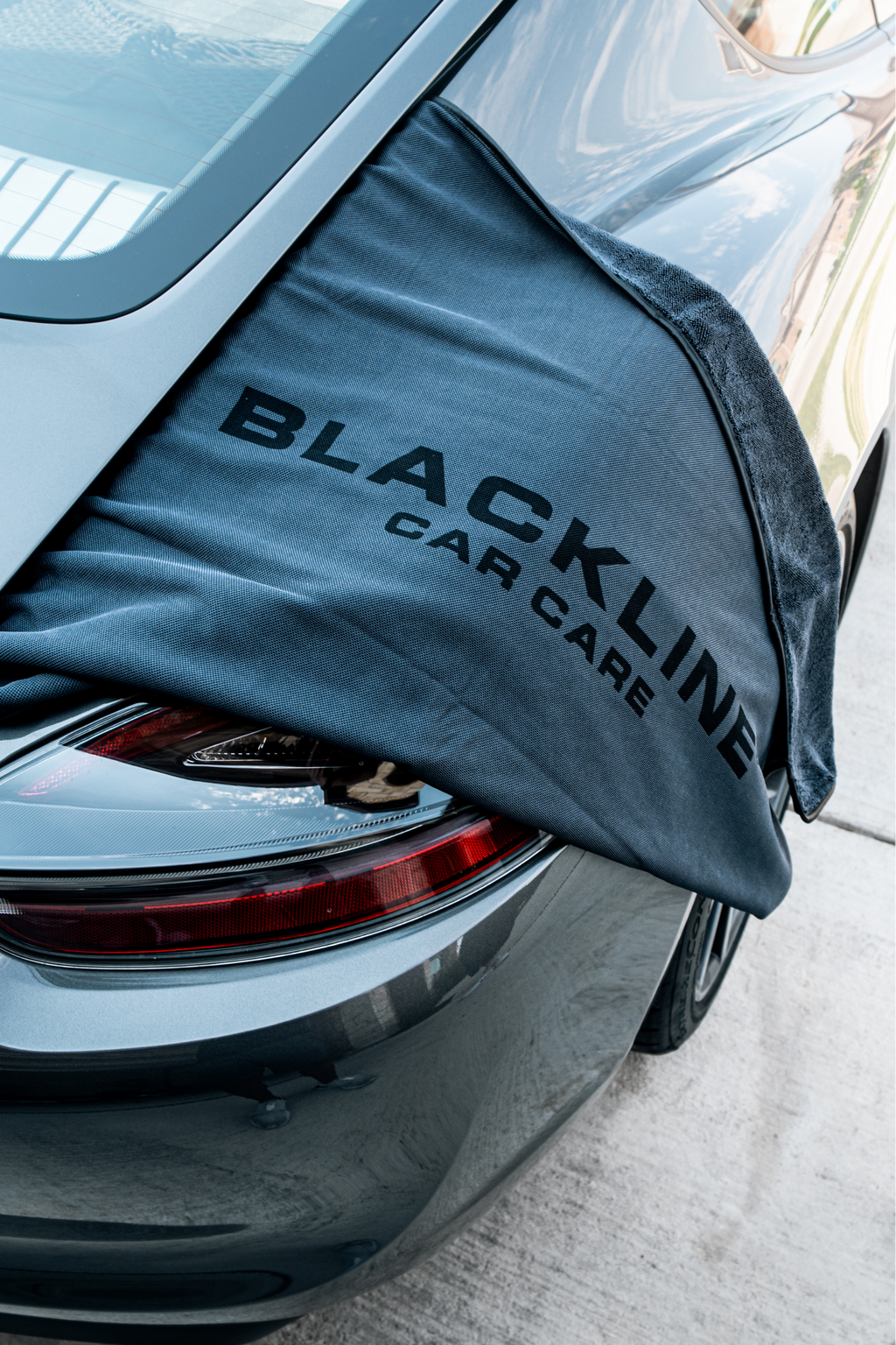 Compact BLACKLINE drying towel stored in a vehicle trunk