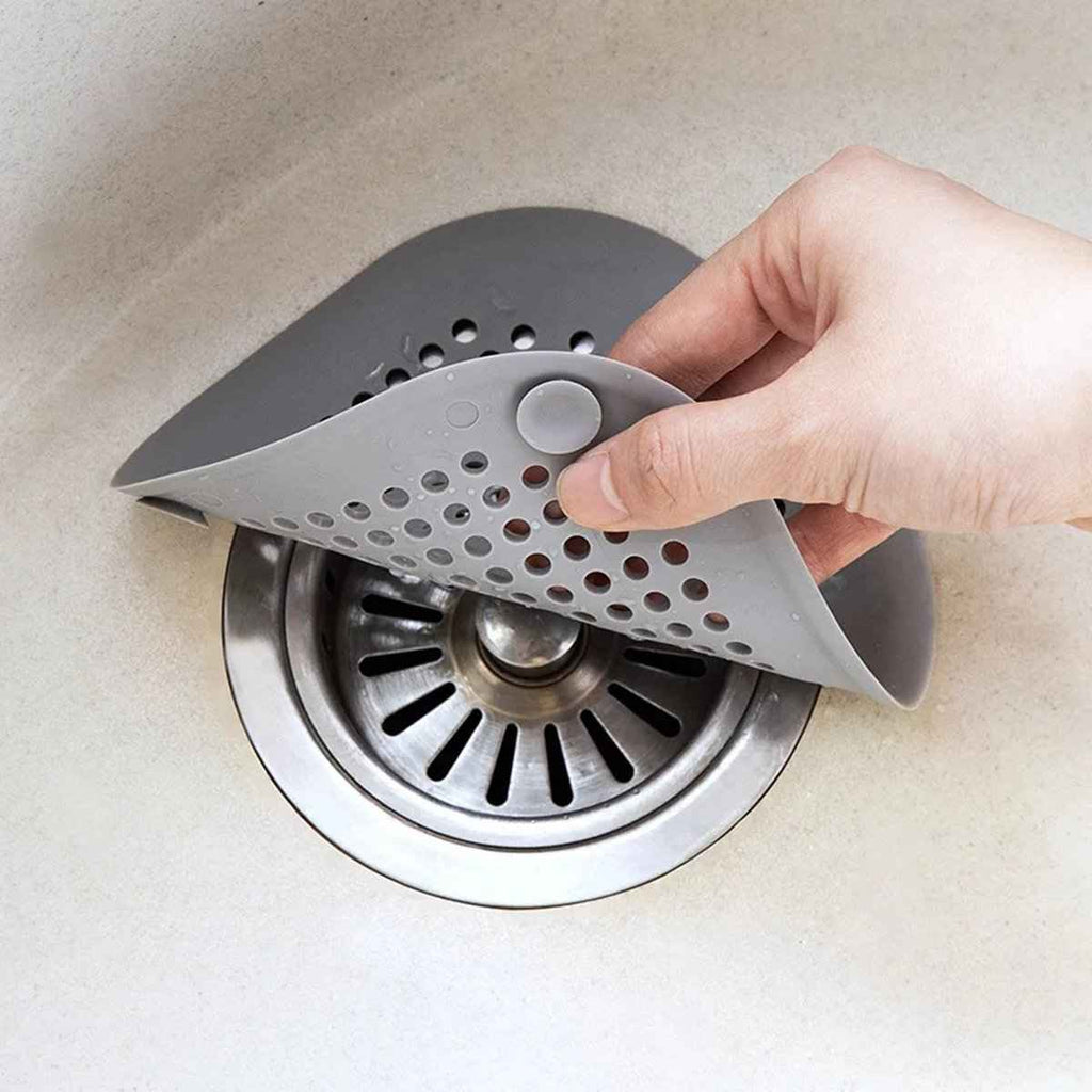 Silicone drain catcher covering a sink or shower drain