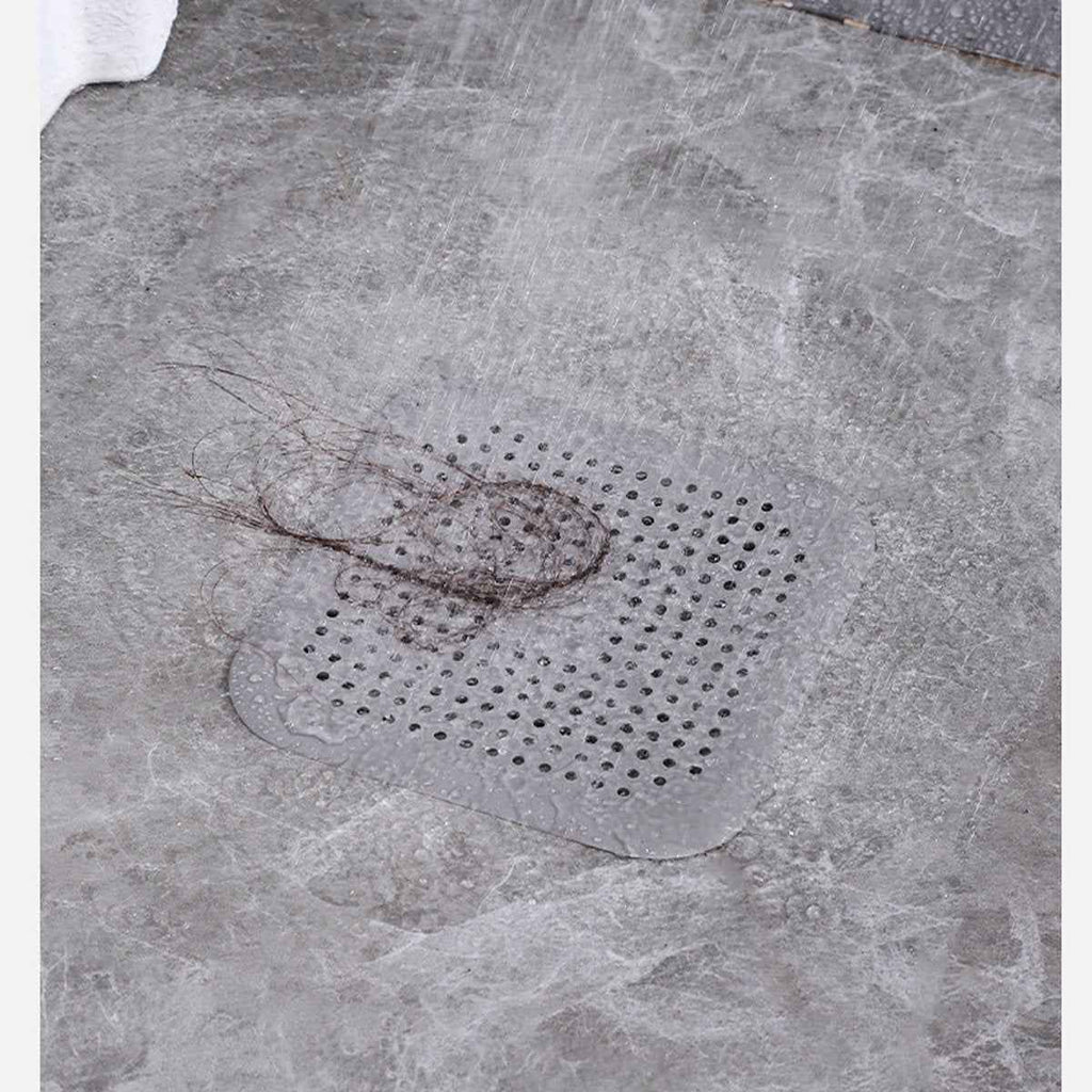 Silicone drain strainer shown flat over a household drain